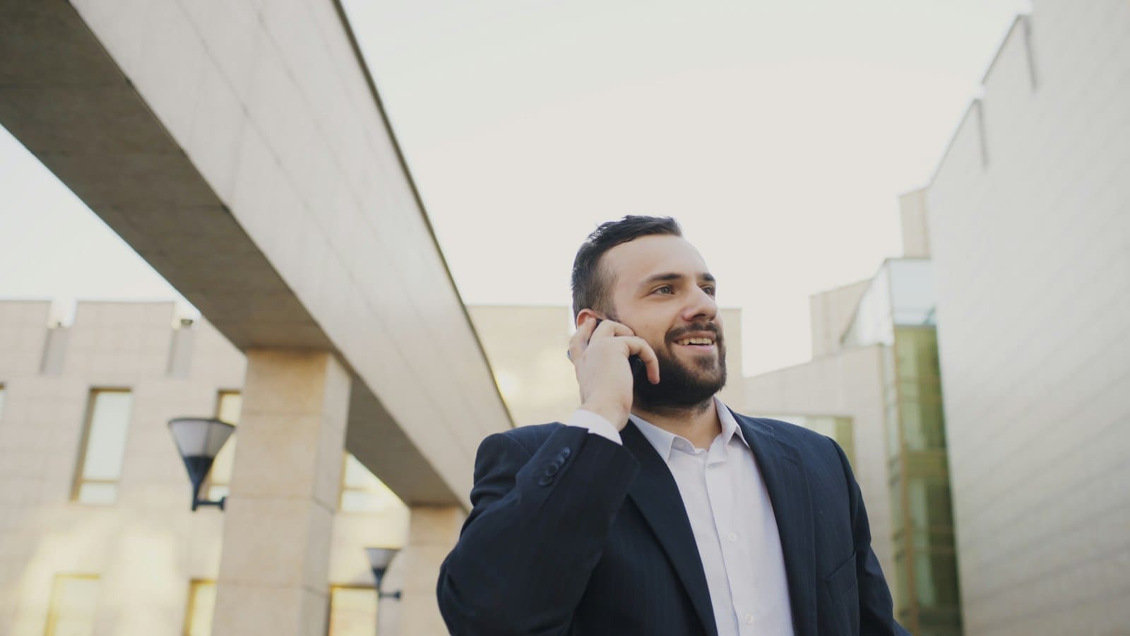 A staff member taking a call outdoors